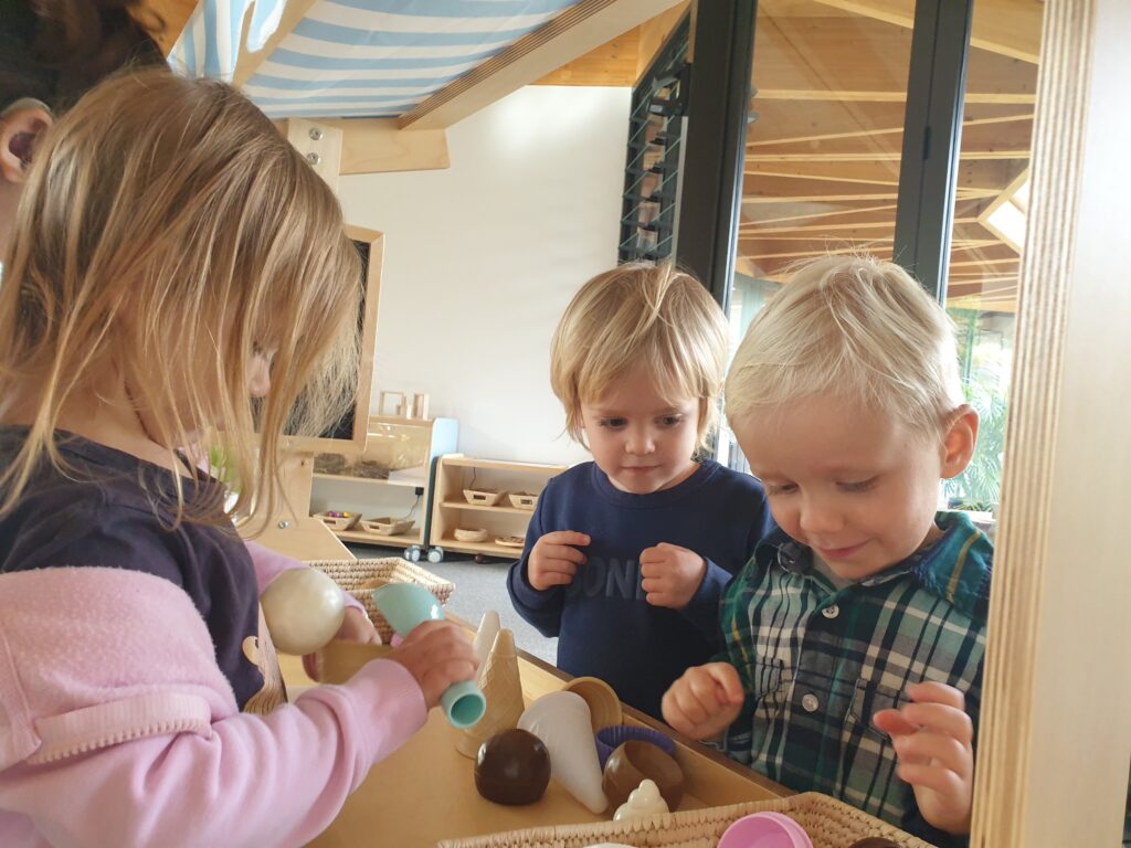 Preschool children at pretend play in an icecream shop
